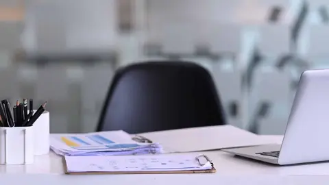 Manager working desk with laptop computer, document, paperwork and office suppliers.