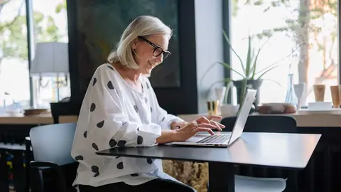 Mujer con ordenador trabajando y sonriendo - Foto de Yan Krukau de Pexels