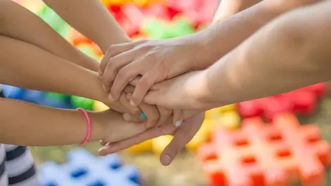 Varias personas uniendo sus manos | Foto de la Comunidad de Madrid