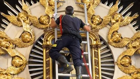Un bombero ante el cuadro de la Virgen de la Paloma - Foto de Archimadrid